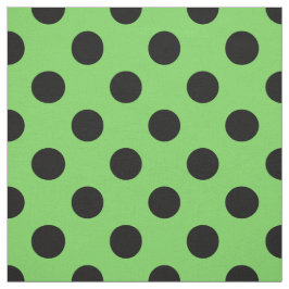 Svart polka dots på kalkgrönt tyg