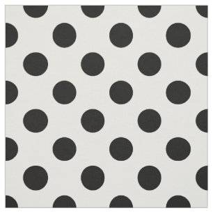 Svart polka dots på vitt tyg