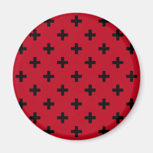 Svart polka kor på rött magnet