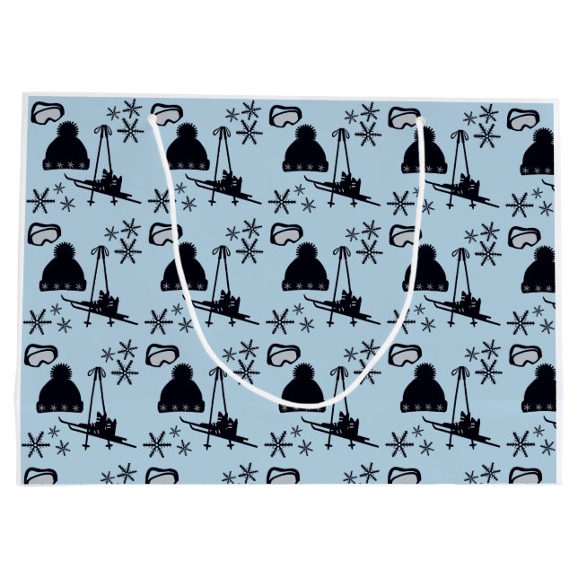 Svart skidutrustning och snöflingor på blå skidutr (Baksidan)