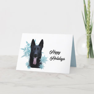 Svart tysk schäferhund i snöflingor helgkort