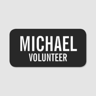 Svart volontärmärke med eget namn namnbricka