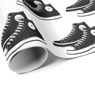 Svarta neakers på vit presentpapper