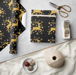 Svarta och gyllene falska folie renar och snöfling presentpapper