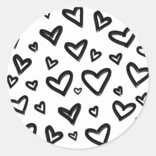 Svarta och vita handritade målade doodle-hjärtan runt klistermärke