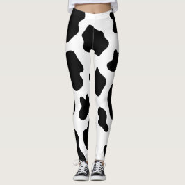 Svarta och vita prickar skriver ut benen från möns leggings