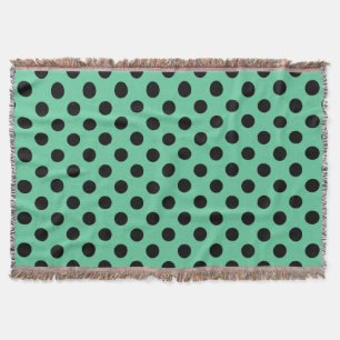 Svarta polka dots på mynta grönt filt
