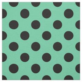 Svarta polka dots på mynta grönt tyg