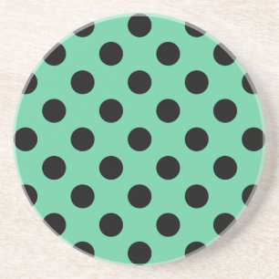 Svarta polka dots på mynta grönt underlägg sandsten