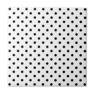 Svarta polka dots på vitt kakelplatta