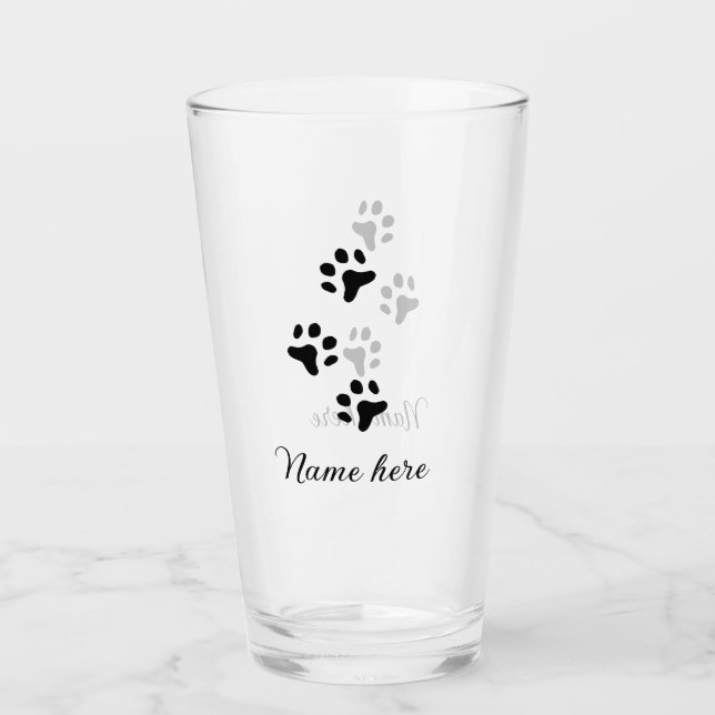 Svartdjuret hund lägger till tass-foto till tass glaskopp (Framsida)