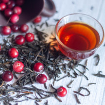 Cup black tea with cranberries