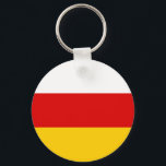 Sydossetiens flagga nyckelring<br><div class="desc">Patriotisk flagga för Sydossetien.</div>