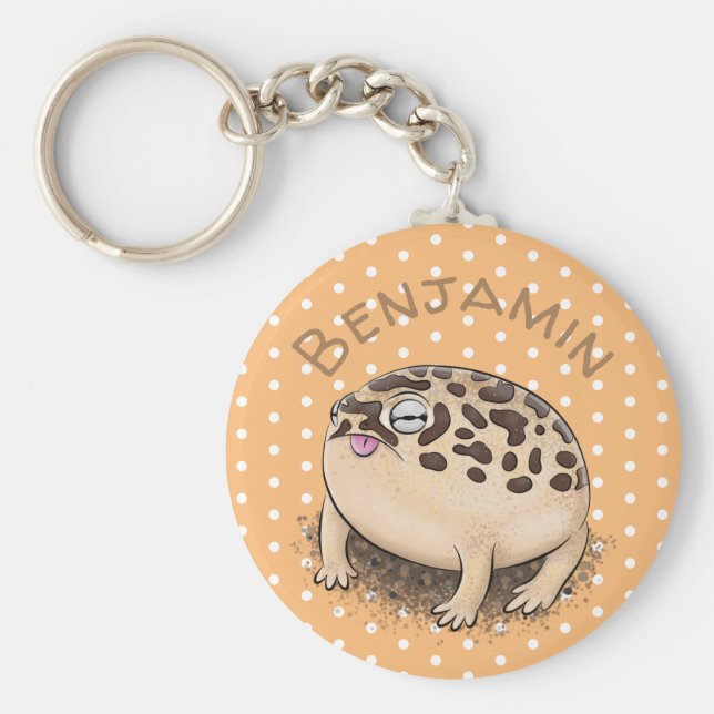 Tecknad illustration av den ljusbruna ökenregngrod nyckelring (Framsidan)