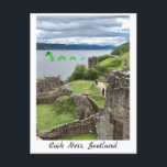 Tecknad Loch Ness Monster & Urquhart Castle Funny Vykort<br><div class="desc">Cute tecknad Nessie (Loch Ness Monster),  ett ljust grönt drakliknande tecknad sjö monster med leende som simmar i ett foto av Loch Ness,  i de skotska högländerna,  med Urquhart-slott i förgrunden. Ett roligt vykort med vacker skotsk miljö. Art och fotografi av Letizia Morley.</div>