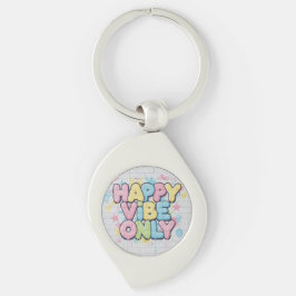 Tegel med färgrik text som säger “ Happy Vibe Only Swirl Silverfärgad Nyckelring