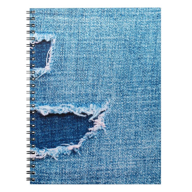 Texturerad denim-bakgrund. Torn hål i tyget Anteckningsbok (Framsidan)