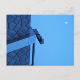 The moon hangs above the breakwater.  vykort