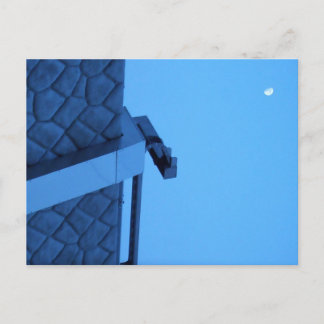 The moon hangs above the breakwater. vykort