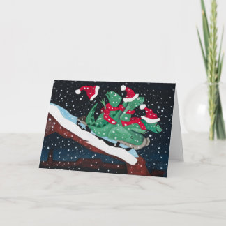 Three sledding dinosaurs helgkort