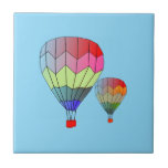 Tile - Striped Hot Air Balloons Kakelplatta<br><div class="desc">Two hot air balloons. Rainbow chevrons for red,  orange,  yellow,  green,  and blue. Blue background for sky.</div>