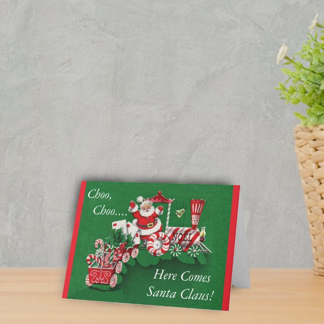 Tomtes jul-tåg helgkort (Santa riding peppermint candy train with letters on a greem Merry Christmas Here comes Santa Card.)