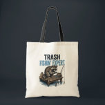 Trash Fishin' Expert Raccoon Tygkasse<br><div class="desc">Are you a fan of raccoons and fishing? This funny 'Trash Fishin' Expert' design features a master raccoon angler on a wooden dock with his gear. Perfect for anyone who loves trash panda memes, outdoor fishing trips, and a good laugh. This vintage-style illustration is a great gift for fishers, outdoorsmen,...</div>