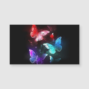 Tre Glowing Butterflies på nattbakgrund