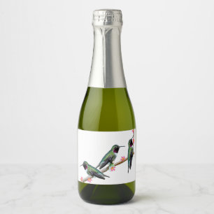 Tre Hummingbird på gren av en blomma