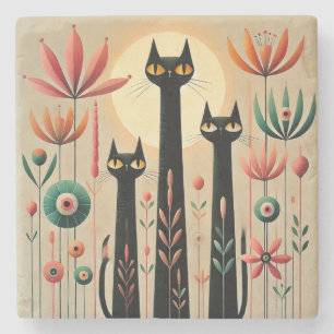 Tre svarta katter mitt i livlig blomsterdesign stenunderlägg