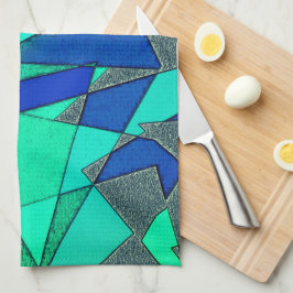 triangulära urklipp i grönt på blå bakgrund, grova kökshandduk