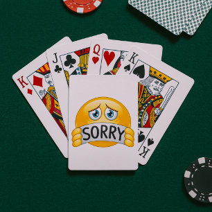 Trist ledsen Emoji-ansikte som håller ett ursäktta Casinokort