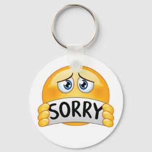 Trist ledsen Emoji-ansikte som håller ett ursäktta Nyckelring