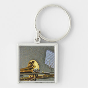Trombone-musikinstrument med notation fyrkantig silverfärgad nyckelring