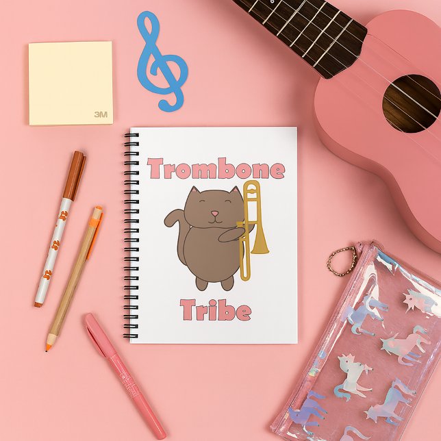 Trombone Tribe Kawaii Brun Katt Rosa Bokstäver Anteckningsbok (A notebook with a cute cat holding a trombone & the words trombone tribe in pink.)