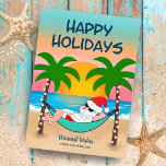 Tropical Beach Santa Hammock jul Julkort<br><div class="desc">Julkortet för tropisk och kustnära tema har tomtslaxning i en hammock på stranden, njuter av havets vinkarare och en färgstark solnedgång och handflatan träd som är ute i stranden ljus. Hälsning överst står "Glad helg" i marinblått. Hälsning i sanden och namn kan vara personlig (visas med "varmaste Önskemål" men fungerar...</div>