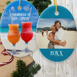 Tropical Marriage First Christmas Photo Keepsake Julgransprydnad Keramik<br><div class="desc">Tropical Christmas,  first married Christmas ornament with photo template and custom text.  Oval,  ceramic ornament with two slushy cocktails on a beach.  Put a photo of the couple / newlyweds on the back.  Customize with text on both sides.</div>