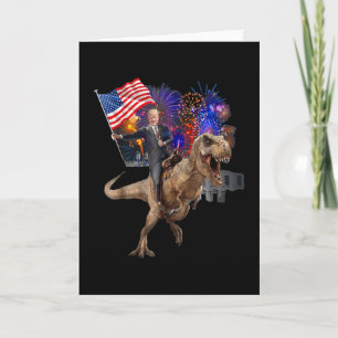 Trump Ridning En Dinosaurie T-Rex Stödjer Trump Kort