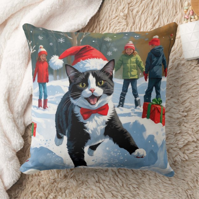 Tuxedokatt springer i snö med julhatt kudde (Filt)
