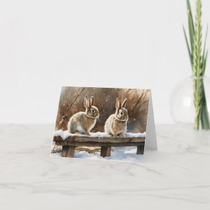 Två Cute Bunny-kaniner på en bench i Snö Blank Kort