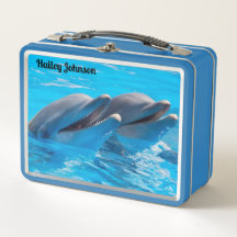 Två delfiner i blå vatten