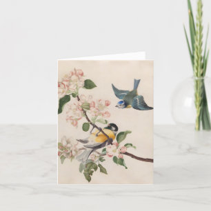 Två små fåglar nära en gren av äppelets blommar. helgkort