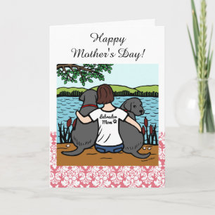 Två svart Labradors och mamma Kort