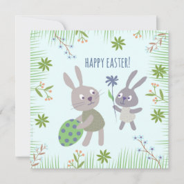 Twee paashaasjes met ei en bloem. kort