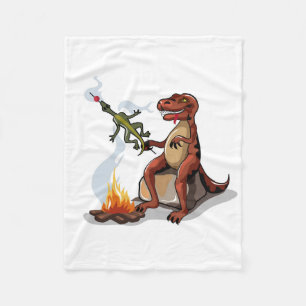 Tyrannosaurus Rex kokar mat över en Campfire. Fleecefilt