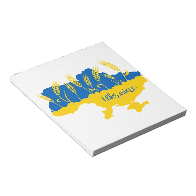 Ukrainas typografi och vetearon på ukrainska flagg anteckningsblock (Vinklad)
