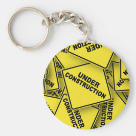 Under konstruktionstecken nyckelring