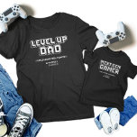 Uppgradera matchning mellan Pappa och underordnade T Shirt<br><div class="desc">Vi firar det ultimata spelbandet med våra "Gamer Pappa och Next Gen Player" som matchar t-shirts! De här skjortorna är perfekter för Fars dag, födelsedagar eller andra spelevenemang. De har återdesignerna "Nivå upp Pappa" och "Nästa spelspelare". Visa din delade passion med fet, pixelbaserad grafik. De här garantierna är idealiska för...</div>