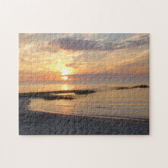 Ursnygg solnedgång över pussel för uddtorskstrand (Horisontell)