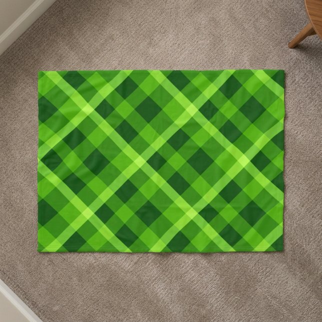 Vacker grön rutmönstrad filt i liten storlek (Top down view of Beautiful Tree Green Plaid Small Fleece Blanket on a carpet floor in a home.)